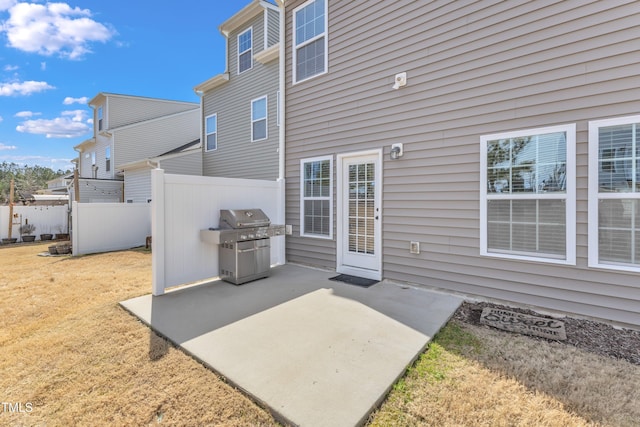 view of patio / terrace featuring a grill and fence