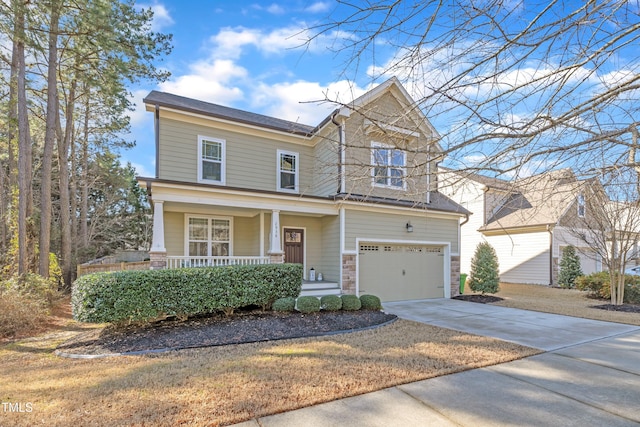 view of front of property with a garage, driveway, and a porch