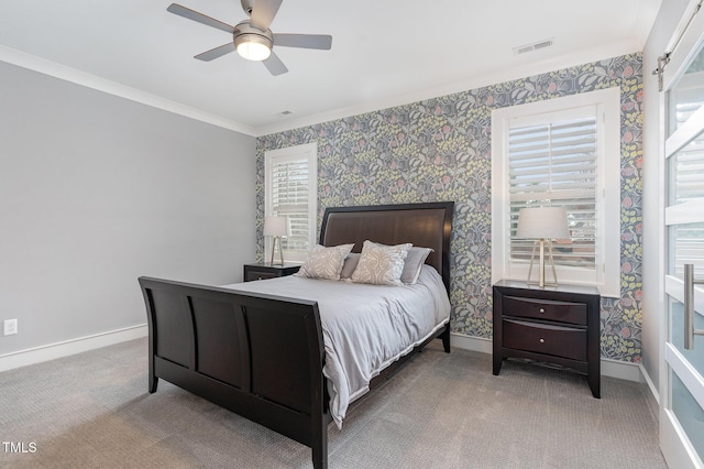 carpeted bedroom featuring crown molding and ceiling fan