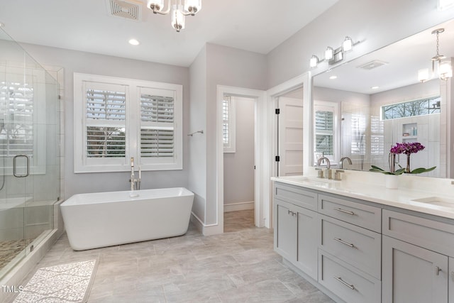 bathroom with vanity, plus walk in shower, and a chandelier