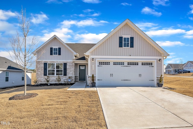 view of front of property featuring a garage, concrete driveway, stone siding, board and batten siding, and a front yard