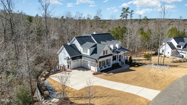 drone / aerial view with a wooded view