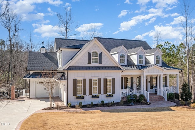 view of front of house featuring driveway, covered porch, a shingled roof, and a standing seam roof