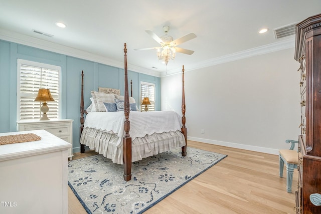 bedroom featuring ornamental molding, visible vents, light wood-style flooring, and baseboards