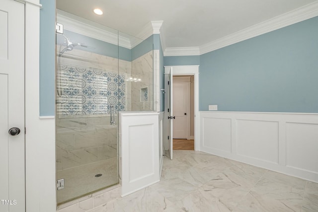 full bathroom featuring marble finish floor, ornamental molding, a decorative wall, and a stall shower