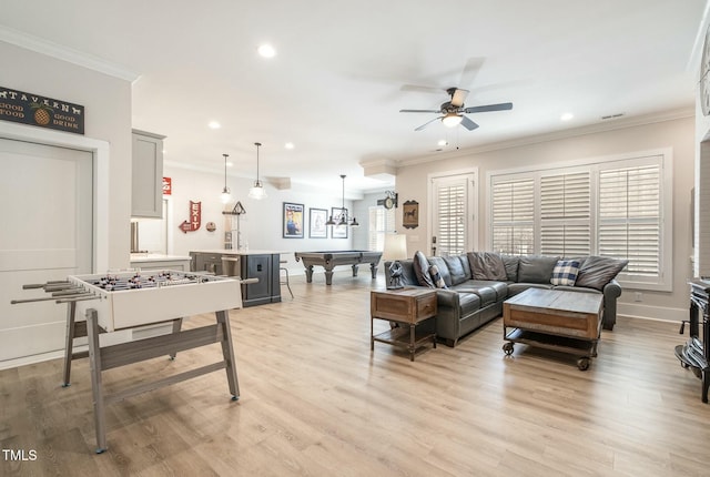 living room with crown molding, pool table, ceiling fan, and light hardwood / wood-style floors