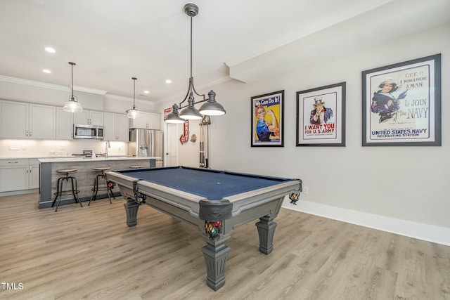 game room featuring crown molding, light wood-type flooring, and billiards