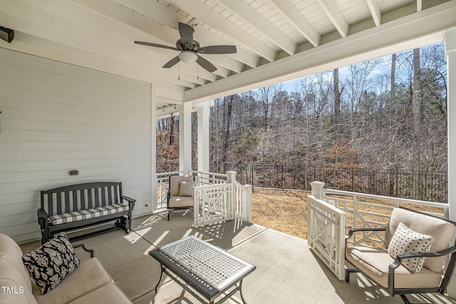 view of patio with ceiling fan and fence