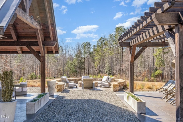 view of patio / terrace featuring an outdoor living space with a fire pit and a pergola