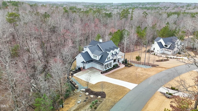 birds eye view of property with a wooded view