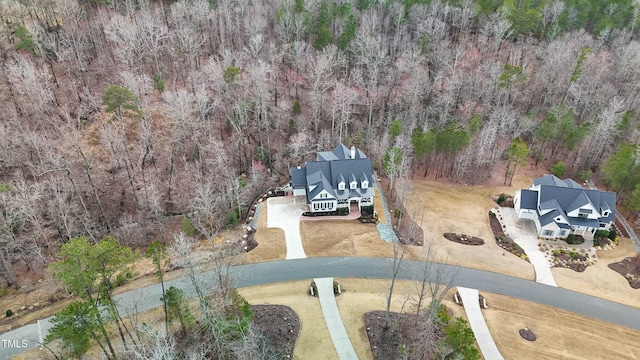 birds eye view of property with a view of trees