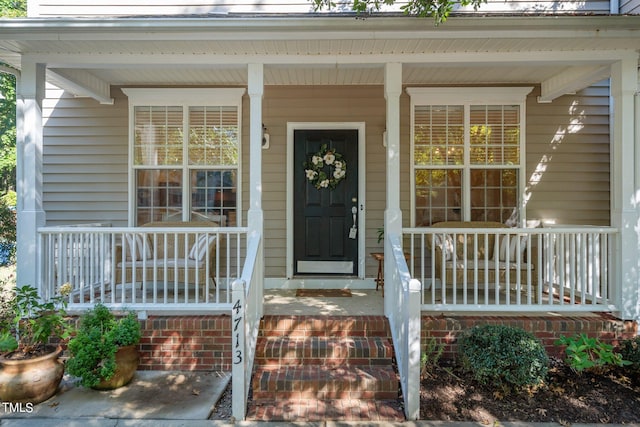 entrance to property featuring covered porch