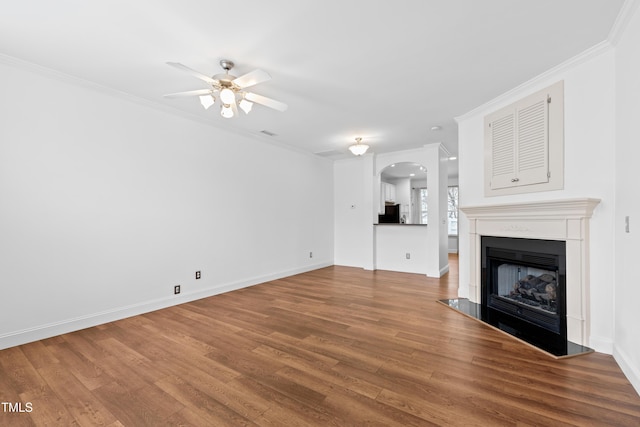 unfurnished living room featuring hardwood / wood-style flooring, ceiling fan, and ornamental molding