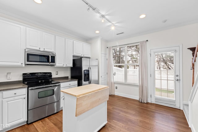 kitchen featuring white cabinetry, stainless steel appliances, and light wood-type flooring