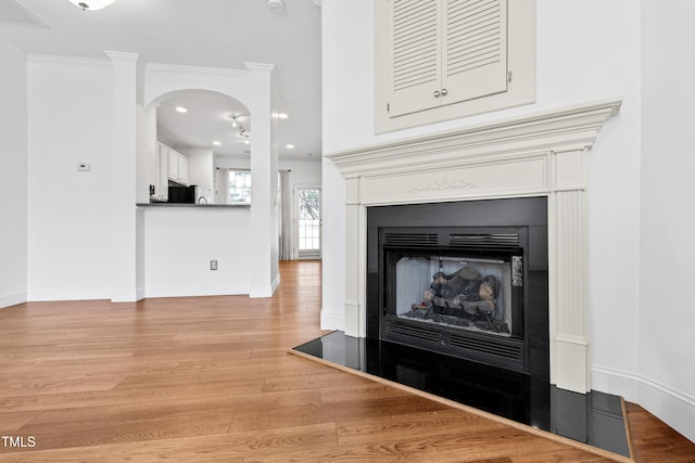 interior details featuring wood-type flooring and ornamental molding