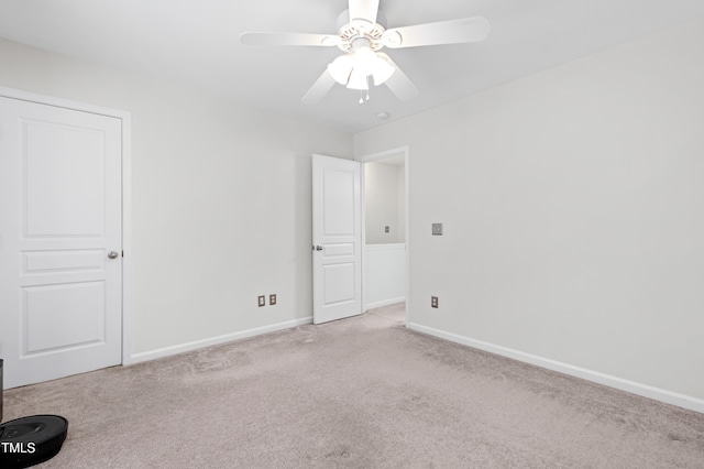 carpeted spare room featuring ceiling fan