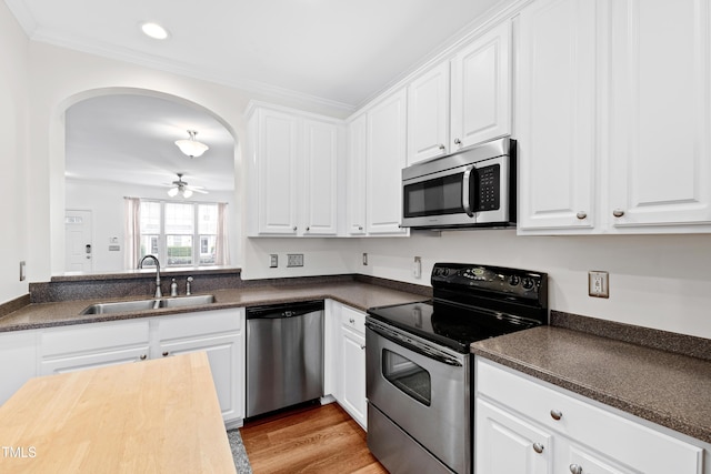 kitchen with sink, stainless steel appliances, and white cabinets