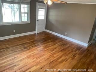 interior space with dark wood-type flooring and ceiling fan