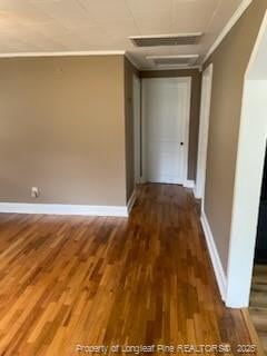 corridor featuring dark wood-type flooring and ornamental molding