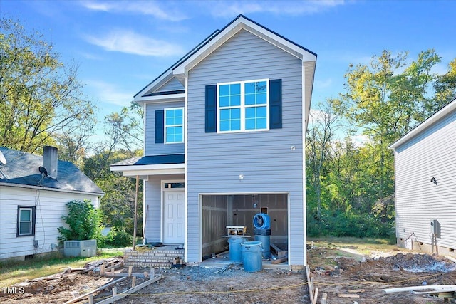 rear view of property with a garage