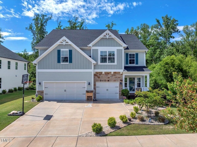 2981 Thurman Dairy Loop, Wake Forest, NC 27587 - craftsman-style home featuring a garage, stone siding, concrete driveway, board and batten siding, and a front lawn