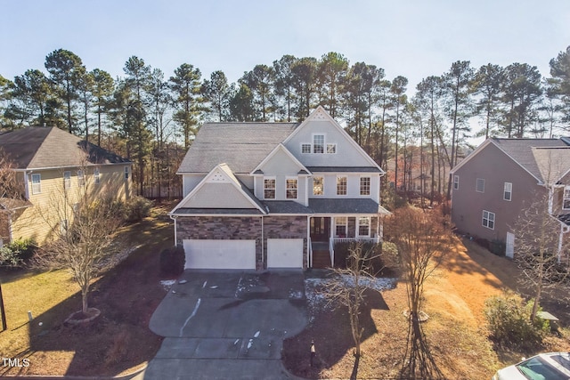 view of property with a garage and a porch