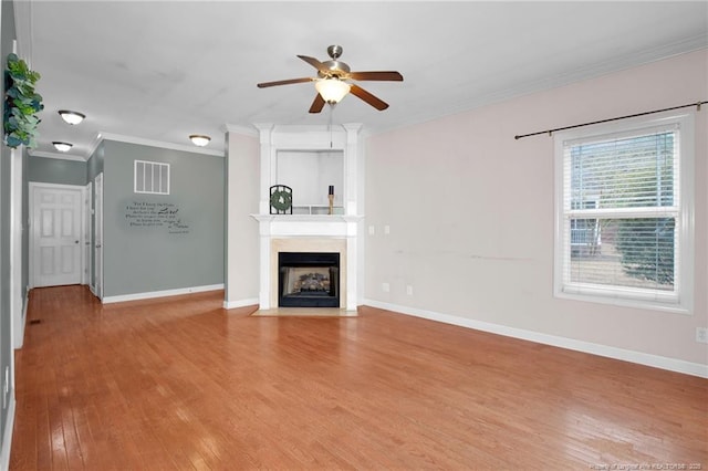 unfurnished living room featuring crown molding, ceiling fan, and light hardwood / wood-style flooring