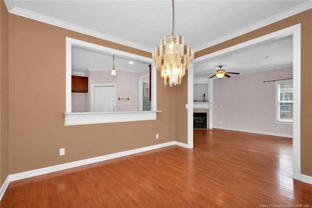 unfurnished living room with crown molding, wood-type flooring, and ceiling fan with notable chandelier