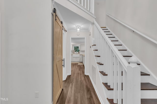 100 Windvale Ct, Cary, NC 27518 - stairs featuring a barn door, crown molding, and wood finished floors