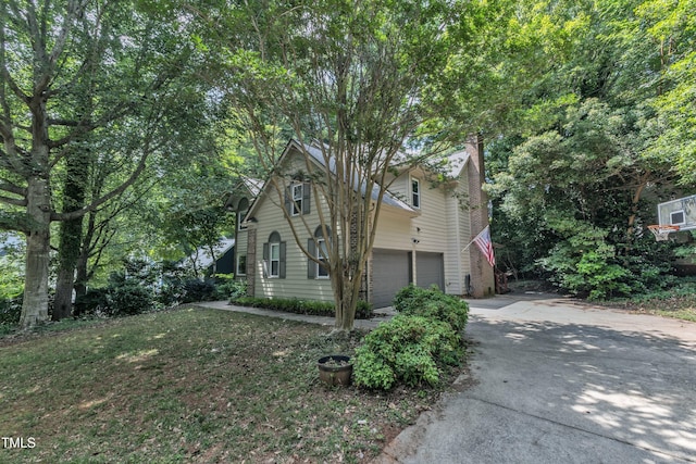 100 Windvale Ct, Cary, NC 27518 - view of front of home featuring a chimney, driveway, and an attached garage
