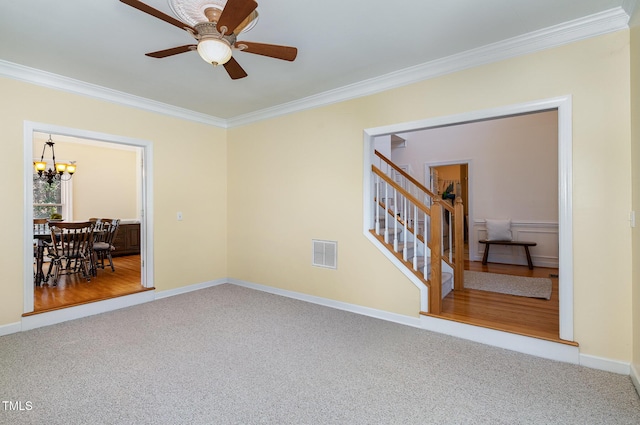 unfurnished room featuring ceiling fan with notable chandelier, crown molding, and carpet floors