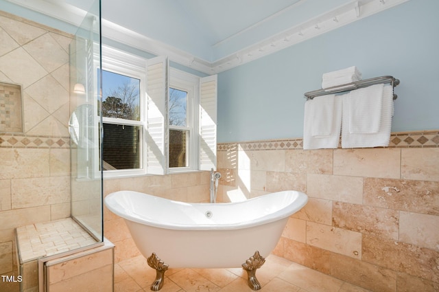 bathroom with tile walls and a bath