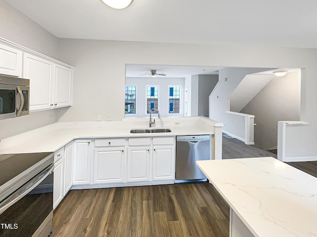 kitchen featuring appliances with stainless steel finishes, sink, dark hardwood / wood-style flooring, and white cabinets