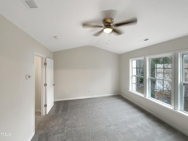 carpeted spare room with vaulted ceiling and ceiling fan