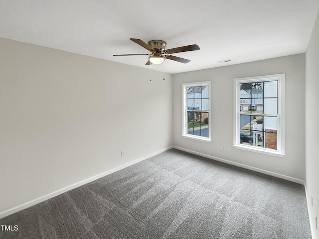 spare room featuring ceiling fan and carpet flooring