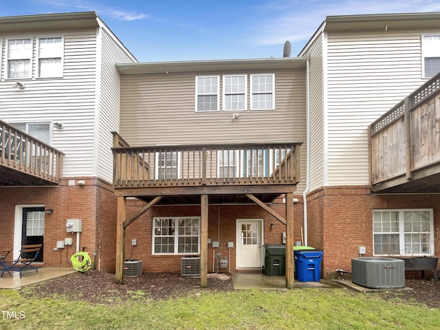 rear view of house featuring central AC unit and a patio area