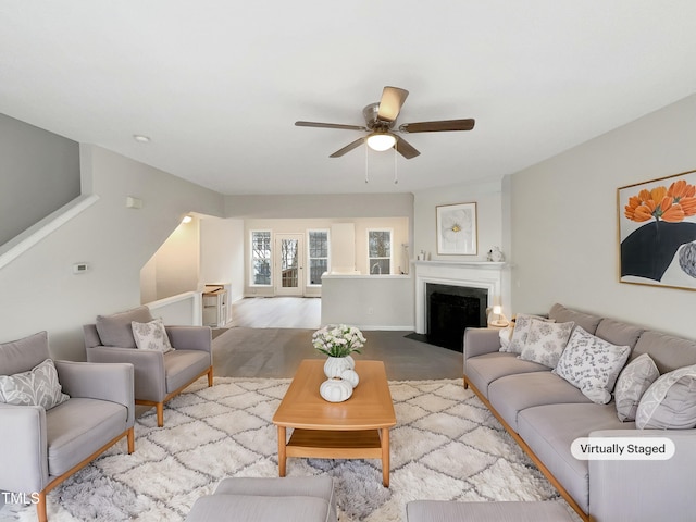 living room featuring ceiling fan and light hardwood / wood-style floors