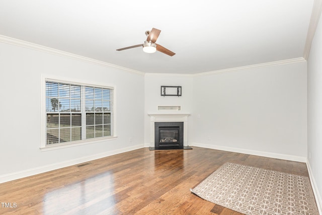 unfurnished living room featuring crown molding, ceiling fan, and hardwood / wood-style floors