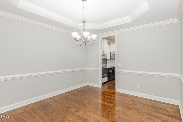 unfurnished dining area featuring an inviting chandelier, crown molding, dark wood-type flooring, and a raised ceiling