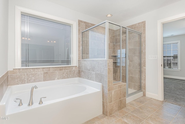 bathroom featuring tile patterned flooring and separate shower and tub