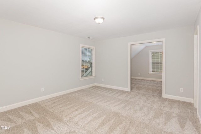 spare room with light carpet