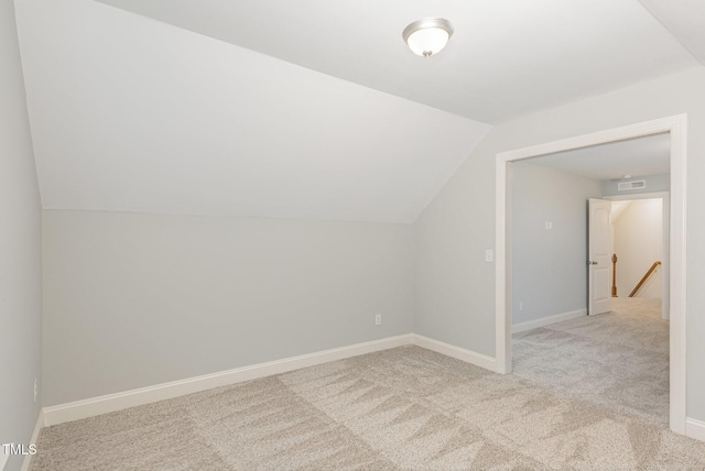 additional living space with lofted ceiling and light colored carpet