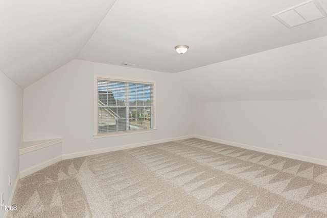 additional living space featuring carpet and lofted ceiling