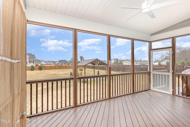 unfurnished sunroom with ceiling fan and lofted ceiling