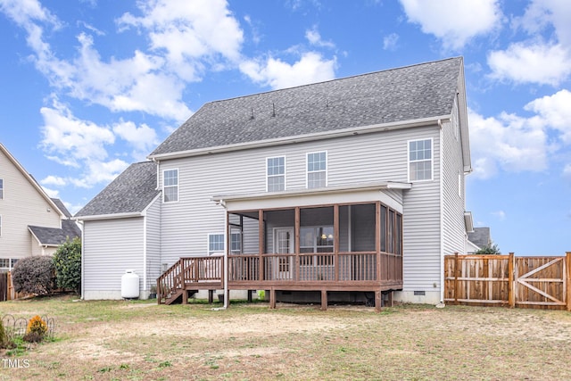 back of property with a wooden deck, a sunroom, and a lawn