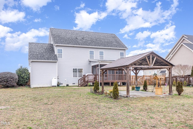 rear view of house featuring a gazebo, a patio area, and a lawn