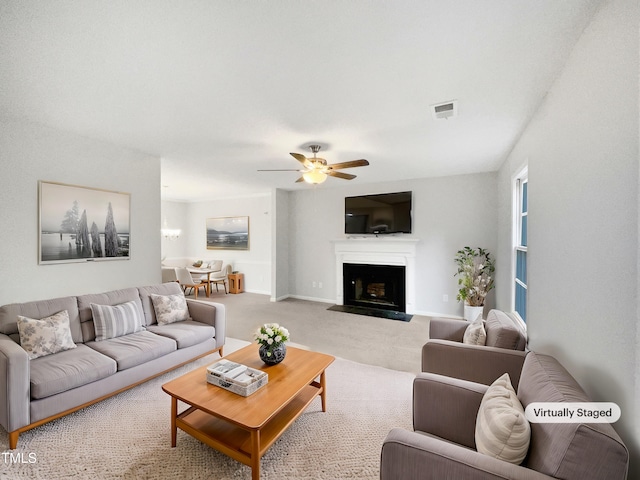 carpeted living room with ceiling fan