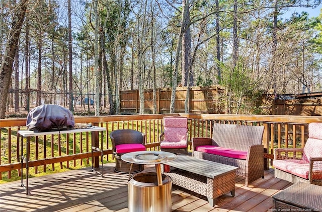 wooden terrace with an outdoor fire pit