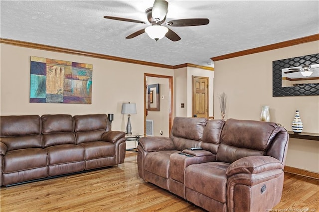 living room with crown molding, ceiling fan, a textured ceiling, and light hardwood / wood-style floors