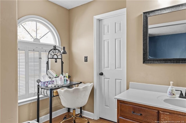 office with sink and light hardwood / wood-style floors